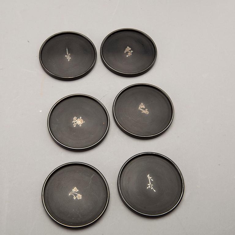 A Swedish 20th century set of 14 plates in bakelite and silver mark of T Wendt Helsingborg 1945.