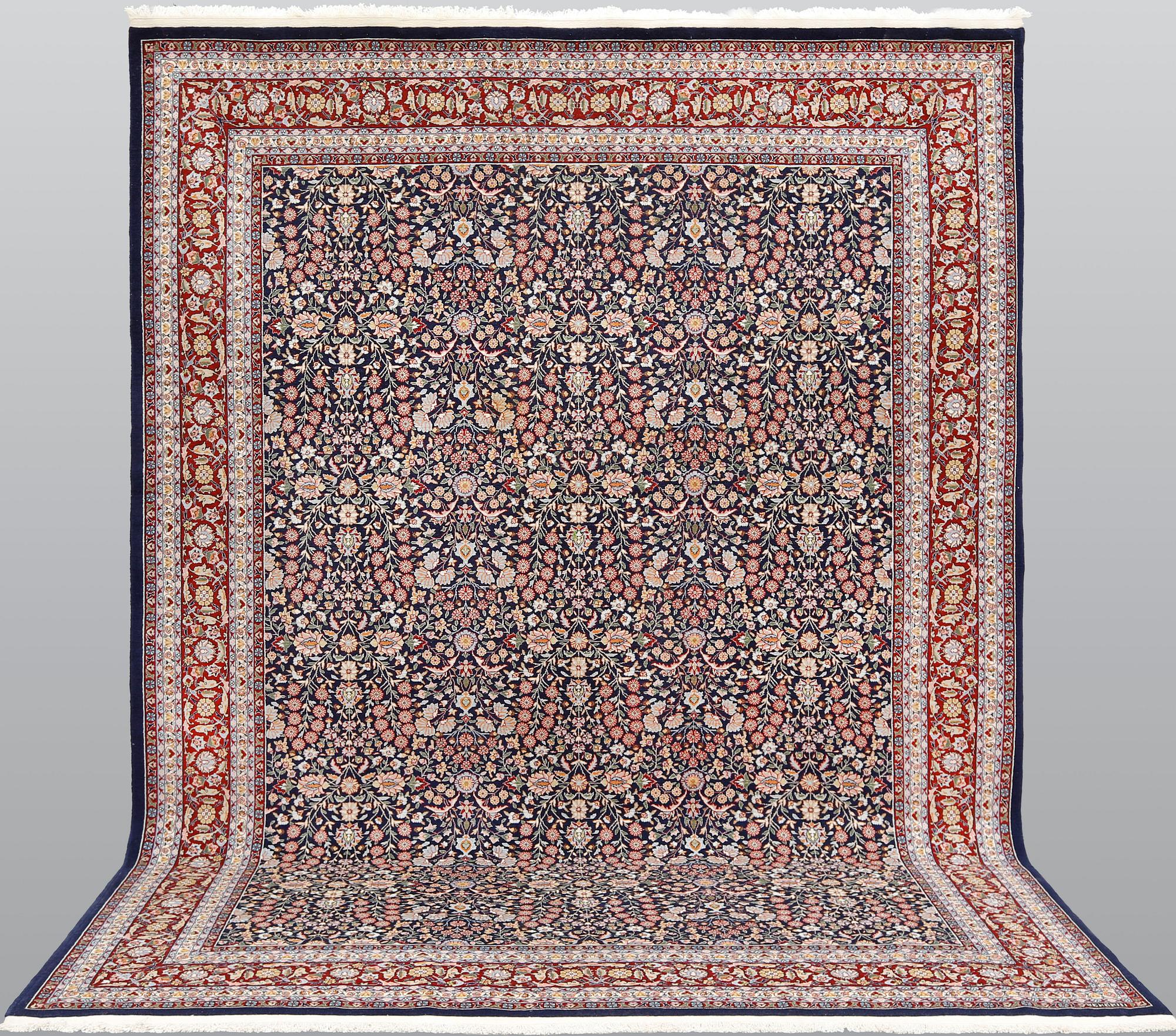 A signed Hereke carpet, ca 340 x 246 cm.