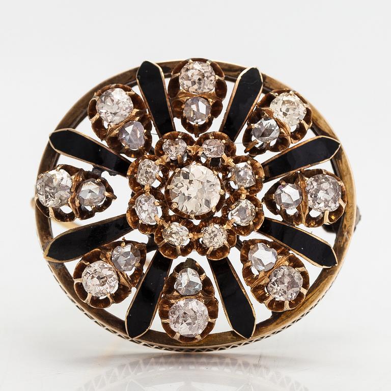 A 12K gold brooch with enamel and old- and rose- cut diamonds.