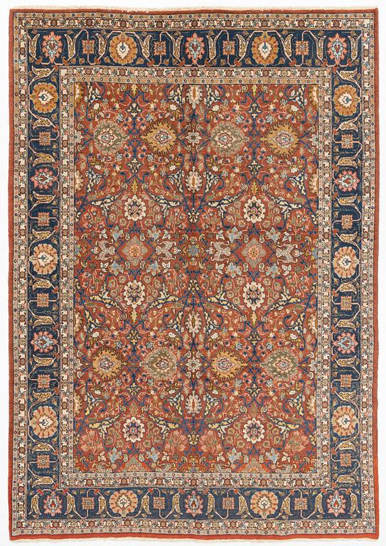 An antique/semi antique Tabriz carpet, c. 325 x 229 cm.