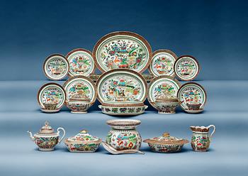 A Canton famille rose armorial dinner service, Qing dynasty, dated 1910. (80 pieces).