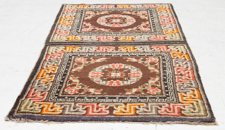 A Chinese two square rug, antique, c. 142 x 71 cm.