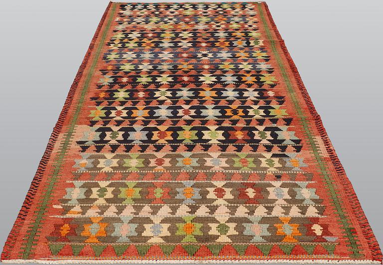 A carpet, Persian Nomad Kilim, ca 324 x 143 cm.