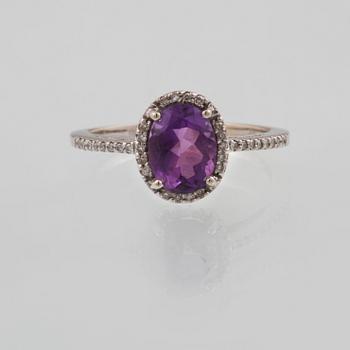 RING, 14K guld med ovalslipad ametist samt åttkantslipade diamanter. Vikt 2,4 gram.