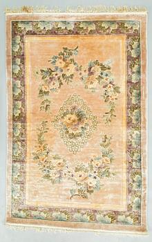 A silk rug, China. Approx. 182 x 122 cm.