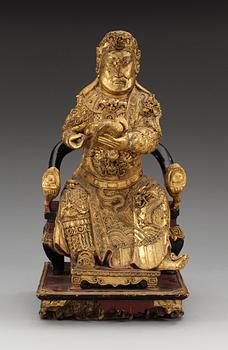 A wooden gilt lacquer figure of a warrior diety, Qing dynasty, 18/19th Century.