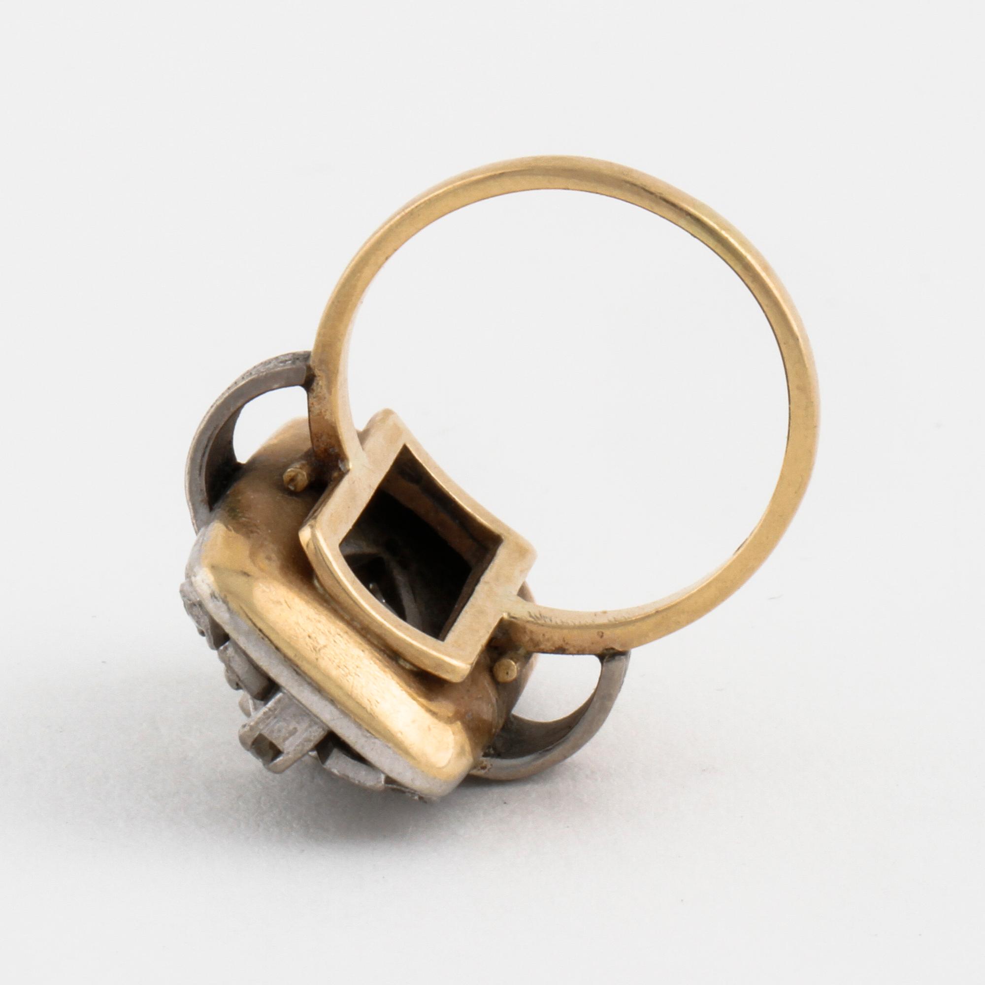 A facet cut diamond ring.