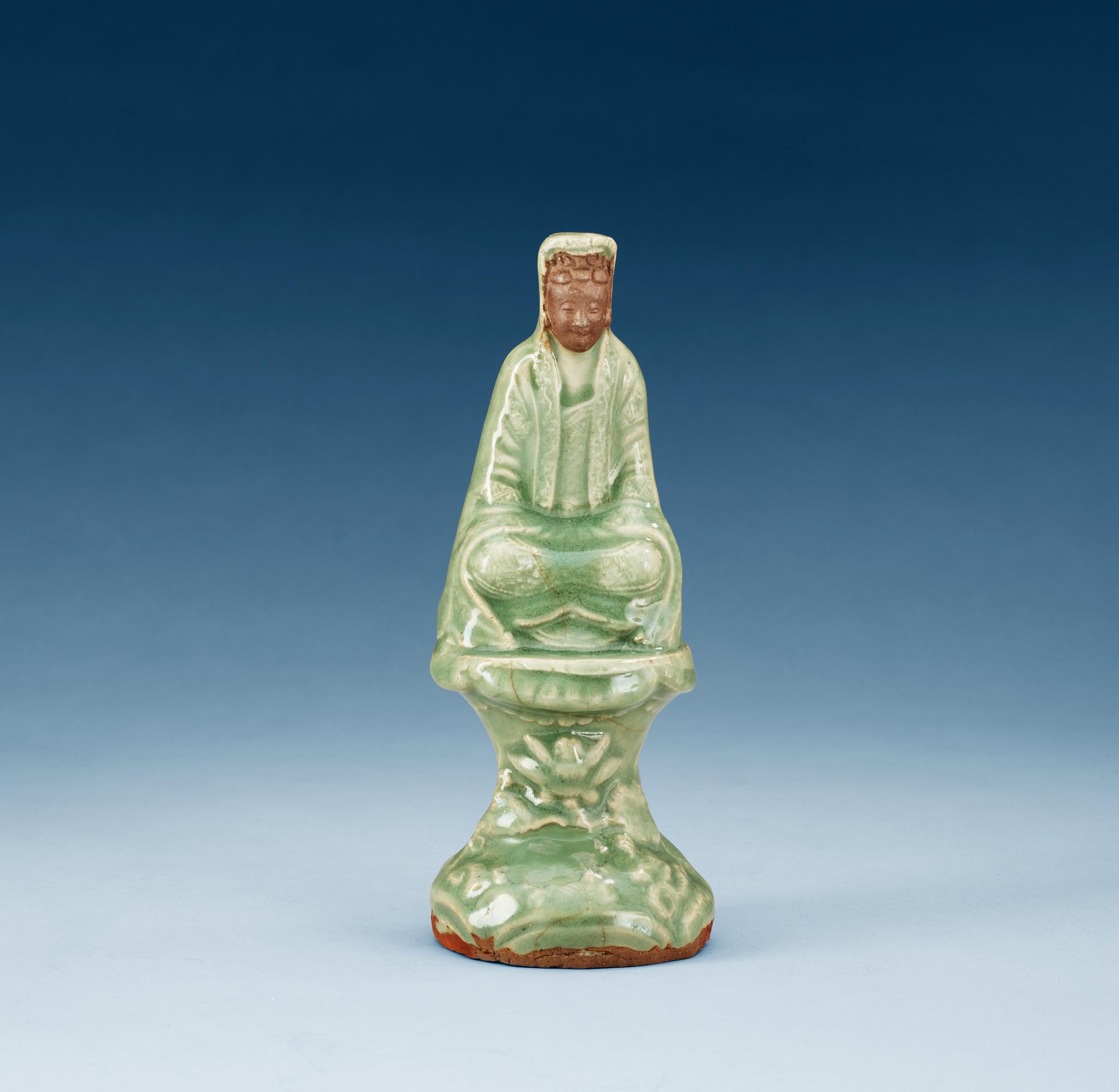A celadon glazed figure of Guanyin, Ming dynasty.