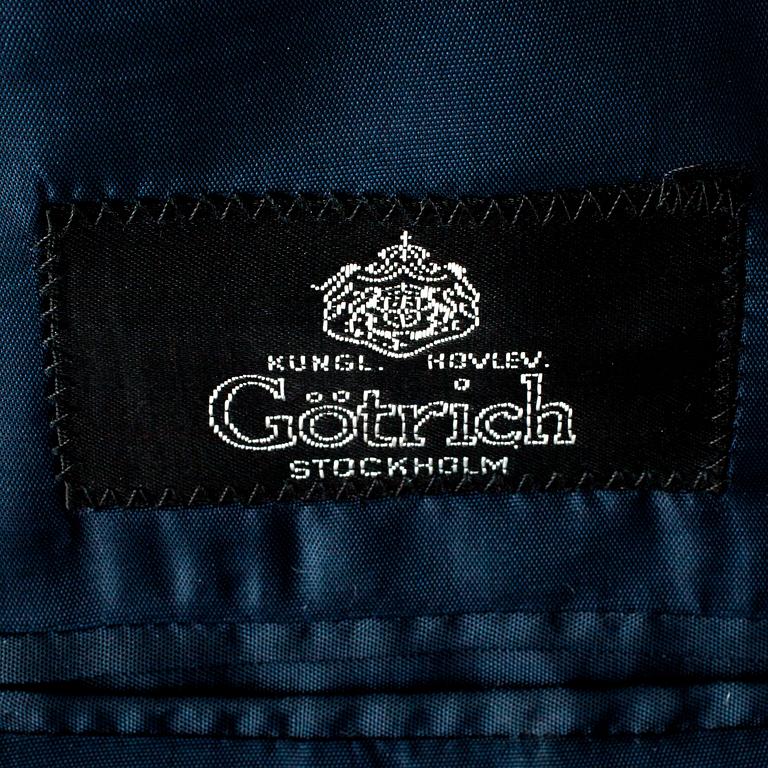 GÖTRICH, a dark blue club blazer and grey wool pants.