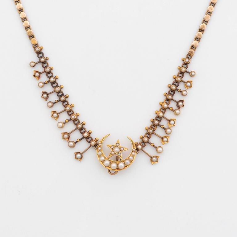 A gold necklace set with pearls.