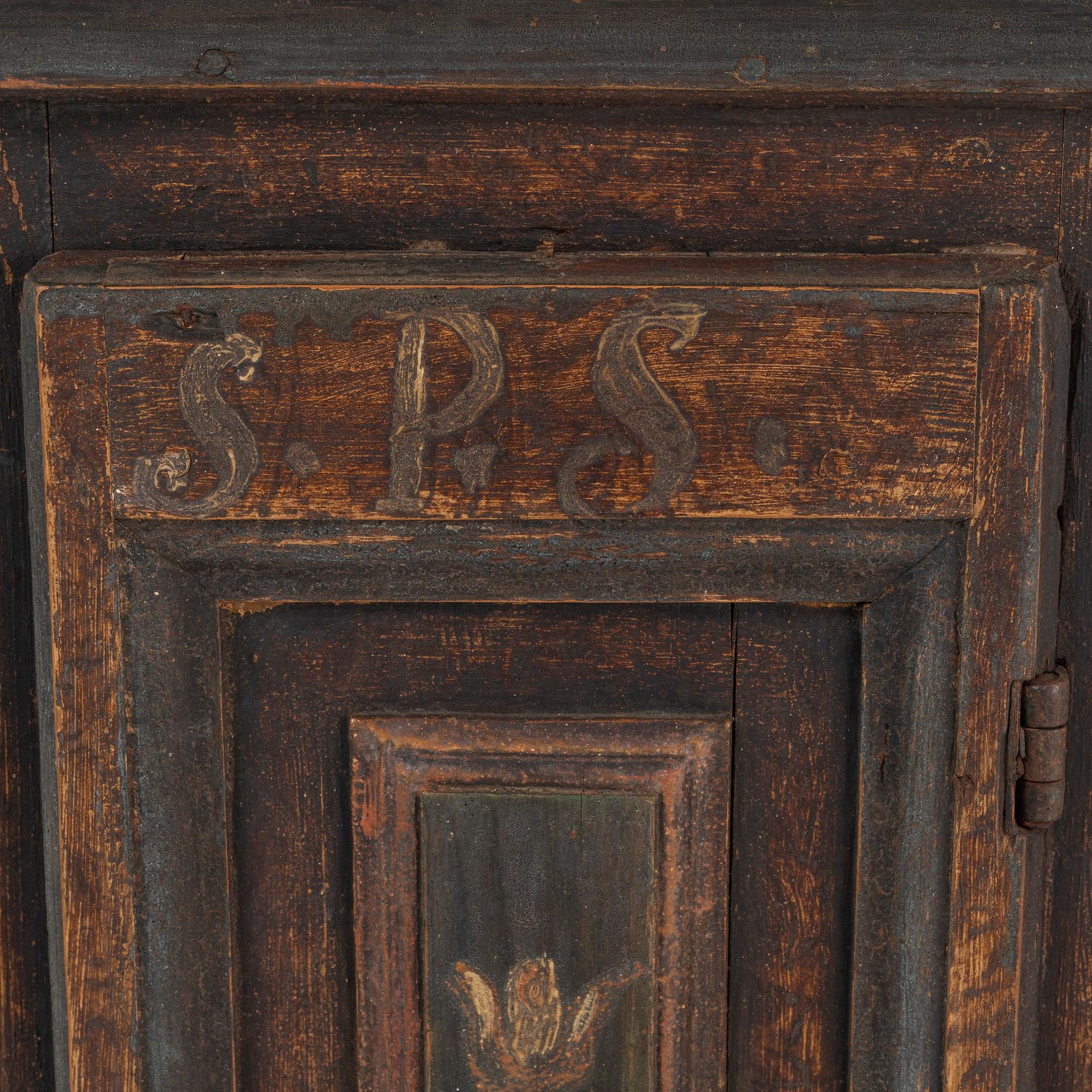 A painted corner cabinet, dated 1800.