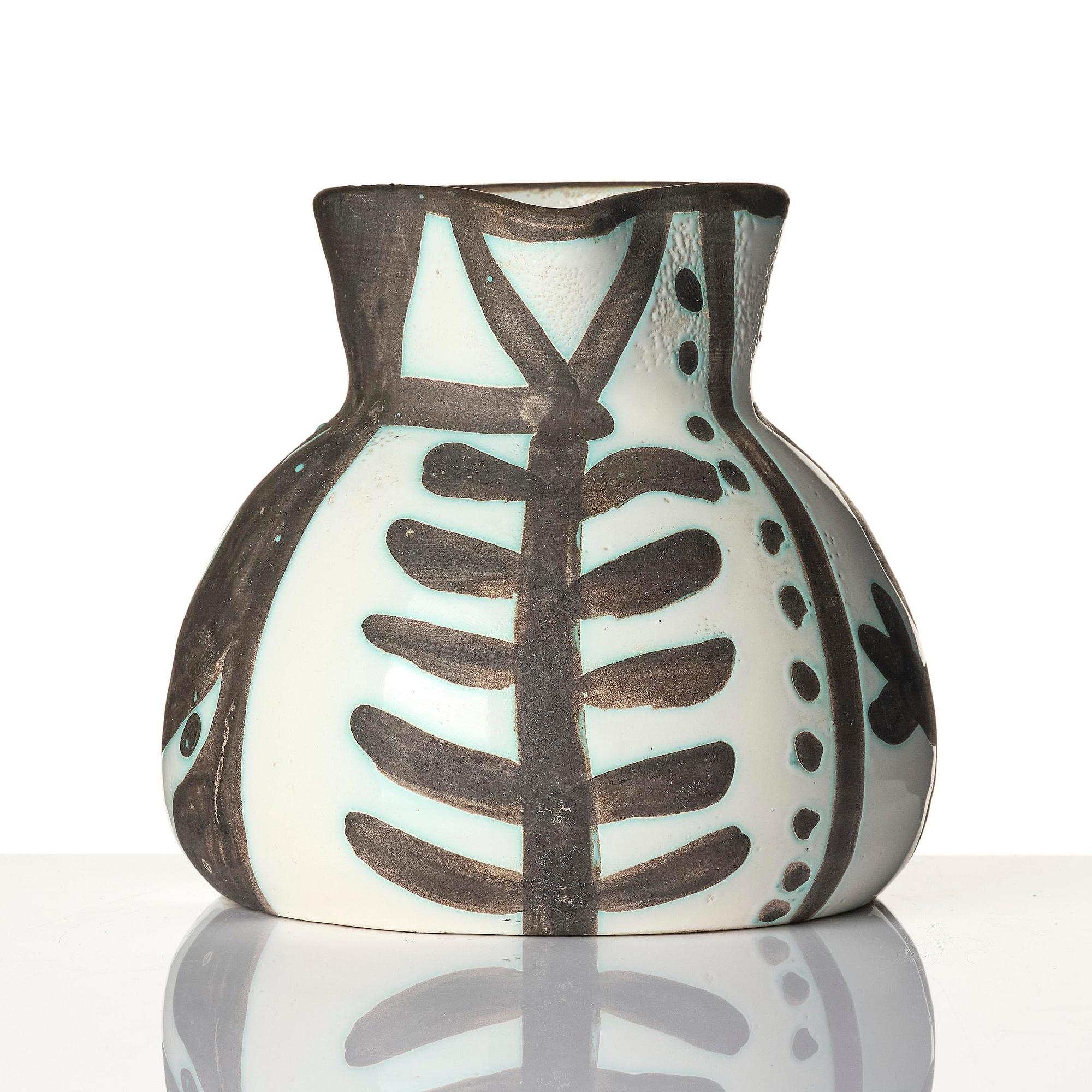 Pablo Picasso, a "Pichet petites têtes" (A.R. 222) faience pitcher, Madoura, Vallauris, France, post 1953.