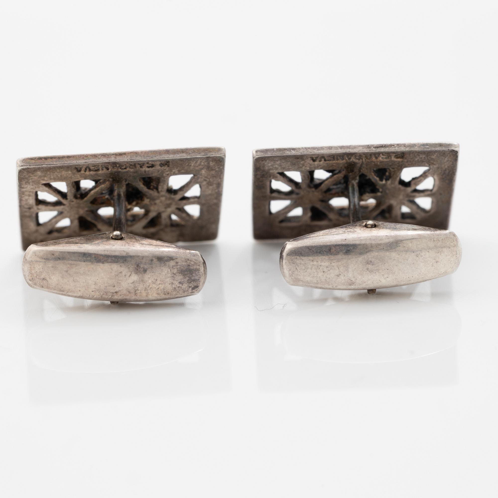 Four silver jewellery pieces: three brooches and a pair of cufflinks. With rose quartz and tiger’s eye. Finnish designers.