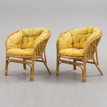 A 1970s four piece set of rattan garden furniture.