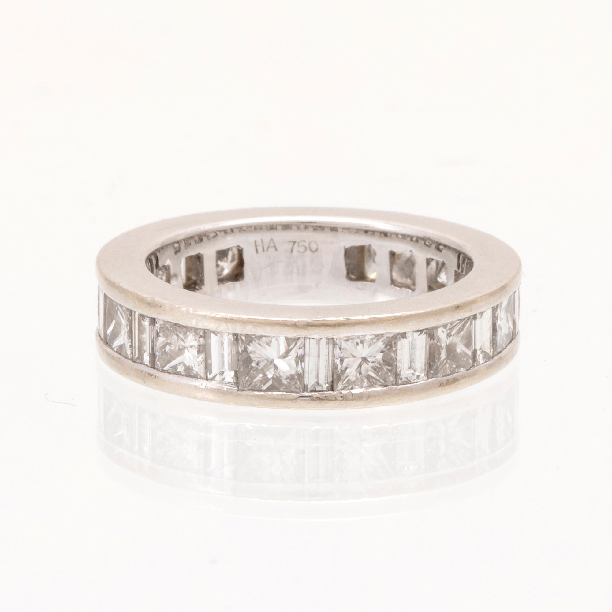 An 18K white gold eternity ring set with baguette and princess cut diamonds by Hartmann's Denmark.