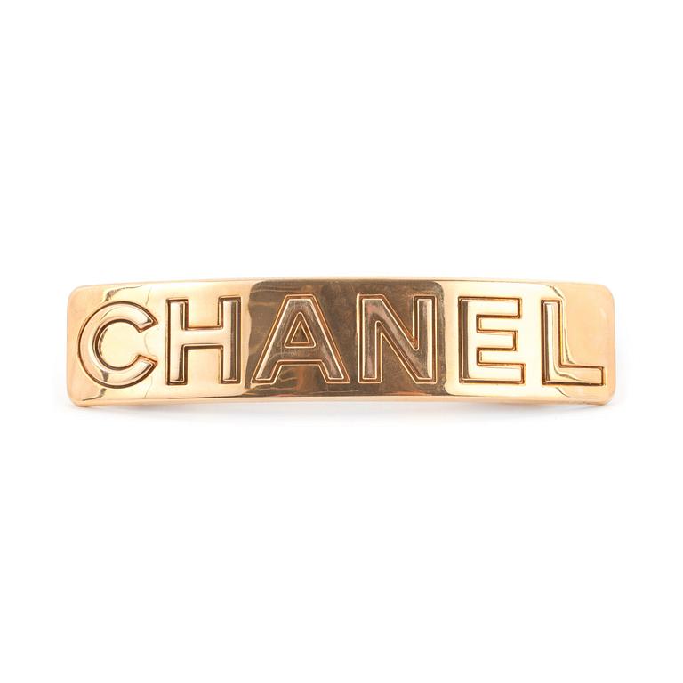CHANEL, a gold colored metall hair clip.