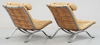 A pair of Arne Norell "Ari" brown leather and steel easy chairs by Norell.