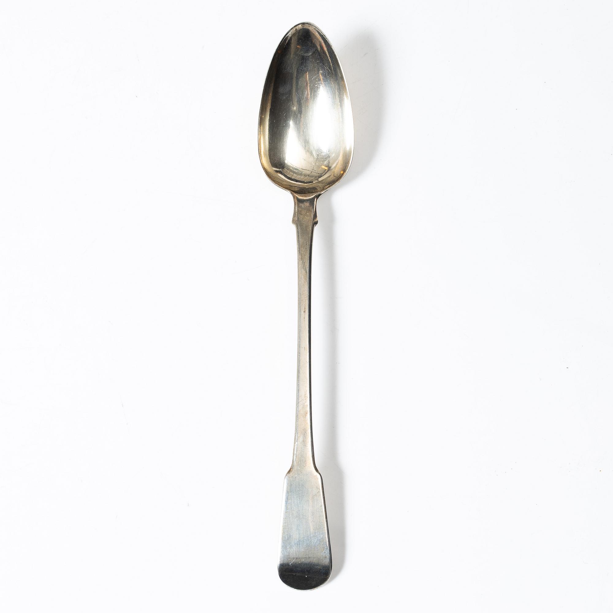 An English silver serving spoon, London 1815.