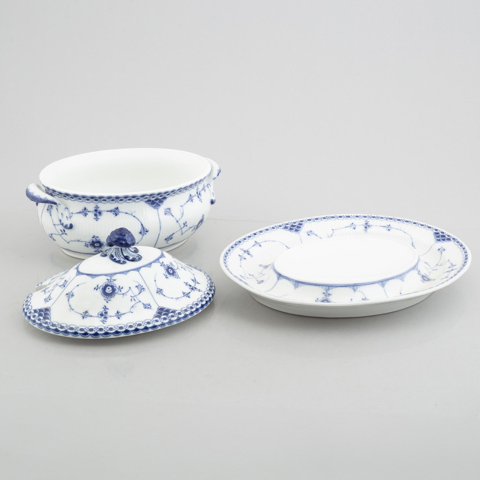 A porcelain 'Blue fluted half lace' / 'Musselmalet' tureen with cover and stand, Royal Copenhagen, 19th century.