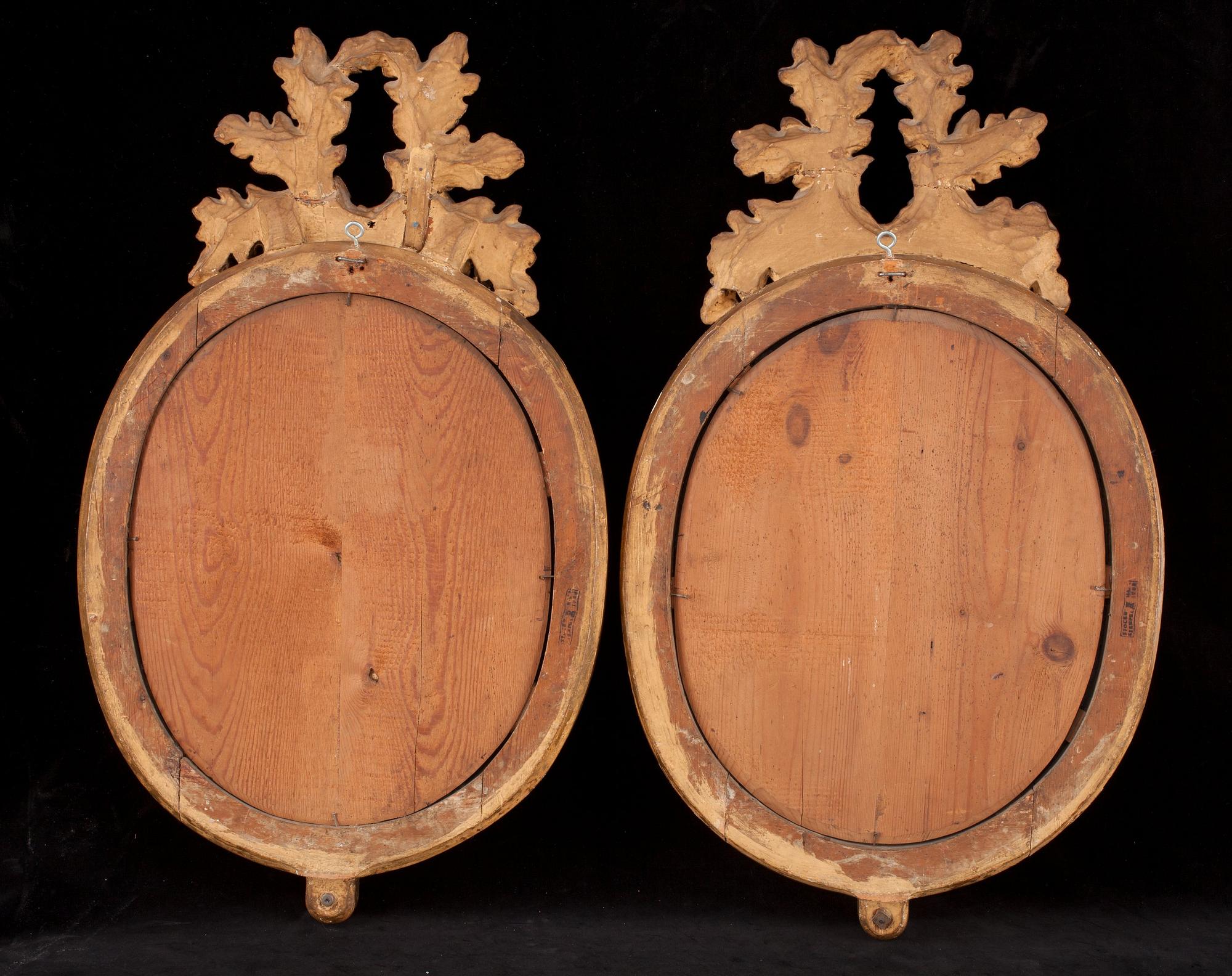 A pair of Gustavian two-light girandole mirrors by N. Meunier.