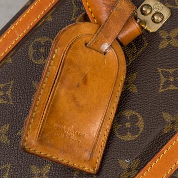 LOUIS VUITTON, a monogram canvas suitcase on wheels.