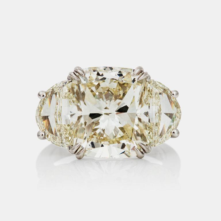 A cushion-cut diamond ring. Center diamond 8.08 ct. Quality circa L-M/SI1. Epaulette-cut side stones 2.63cts in total.