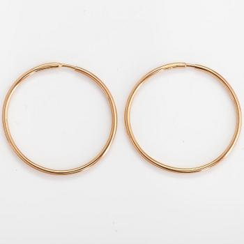 A pair of 14K gold earrings.