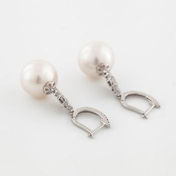 A pair of cultured pearl and brilliant cut diamond earrings.