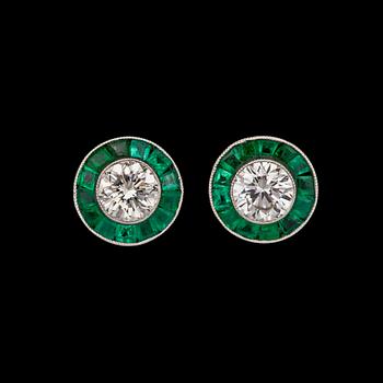 1163. A pair of tapered bagutte and brilliant cut diamond earrings.