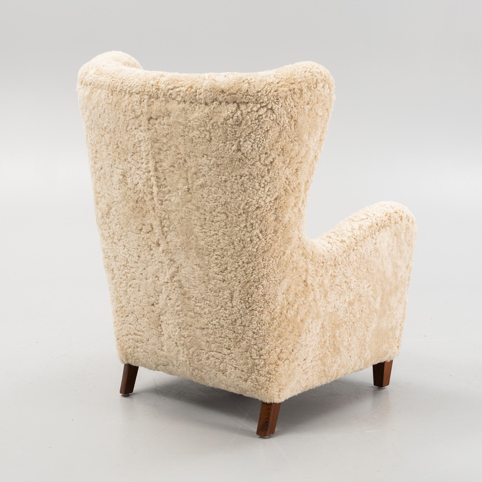 A variation of model 1672 new sheepskin upholstered lounge chair from Fritz Hansen.