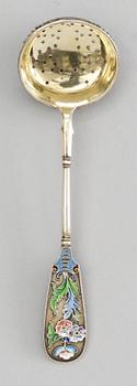 A RUSSIAN SILVER-GILT AND ENAMEL SUGAR SPOON, makers mark of the 11th Artel, Moscow 1908-1917.