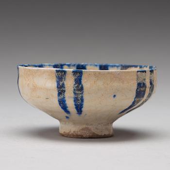 A BOWL, pottery with a white slip and underglaze blue decor, diameter ca 10 cm, Kashan, Persia/Iran early 13th century.