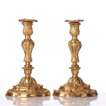 A pair of French Louis XV mid 18th century gilt bronze candlesticks.