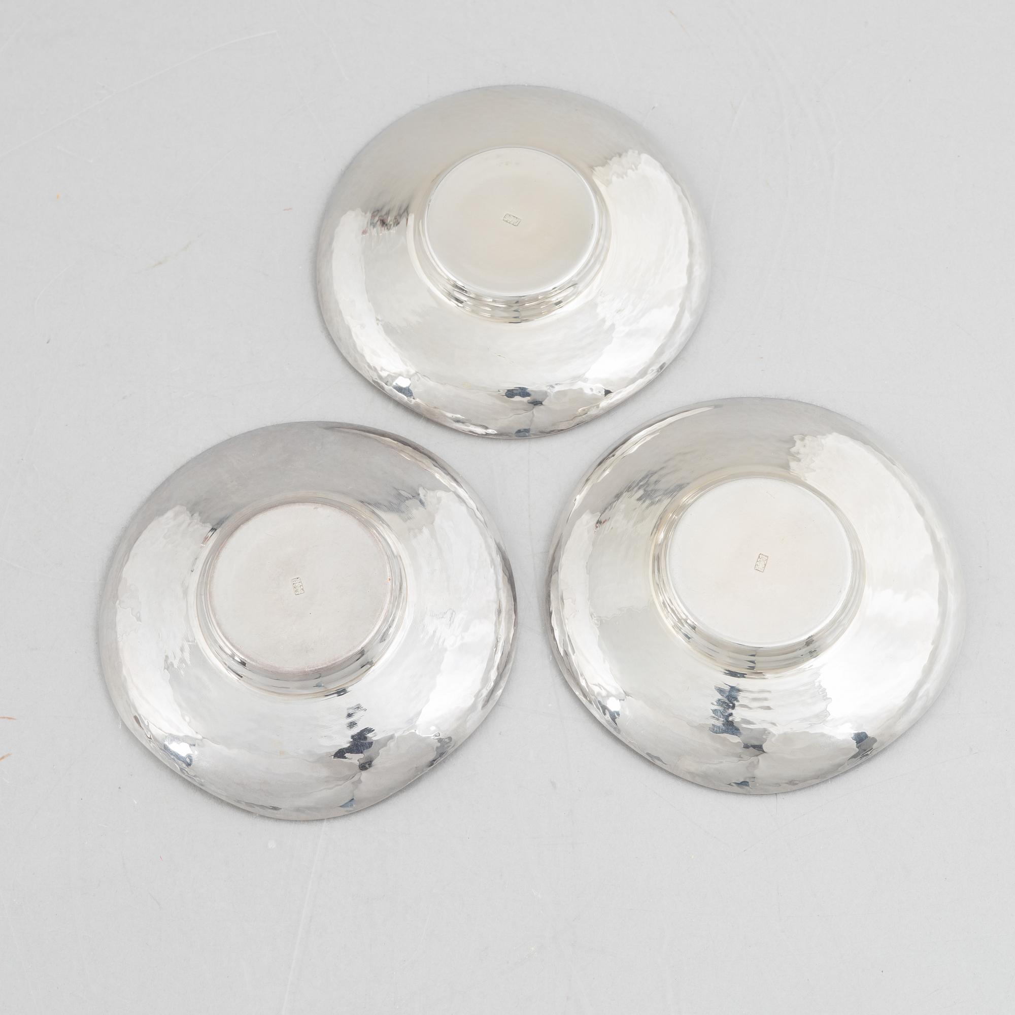 A set of three Japanese silver coasters and a pair of salts with shakers, 20th century.