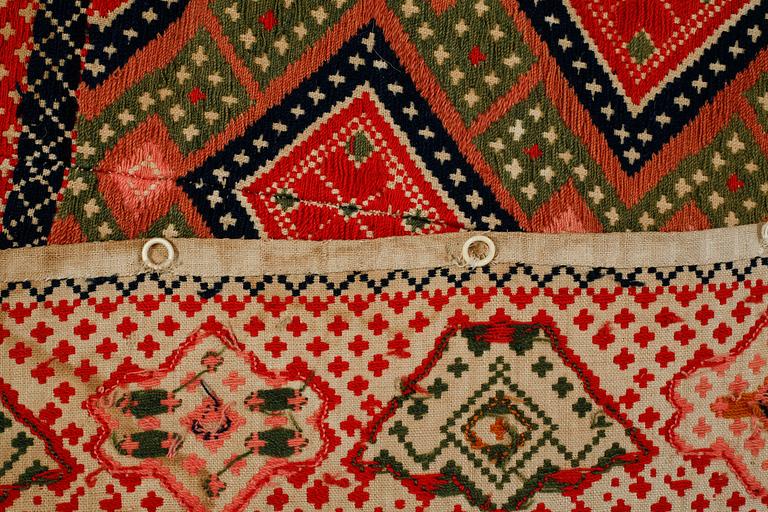 A wall textile, signed, around the year 1900, 208 x 130 cm.