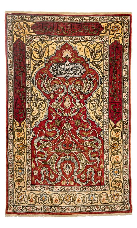 A silk and metal Hereke rug, c. 86 x 52 cm.
