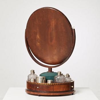 A Swedish Empire circa 1820 mirror on a stand for silver and glass toiletries.