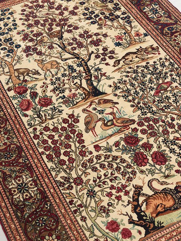 A CARPET, a semi-antique Esfahan figural, 215,5 x 140,5 cm.