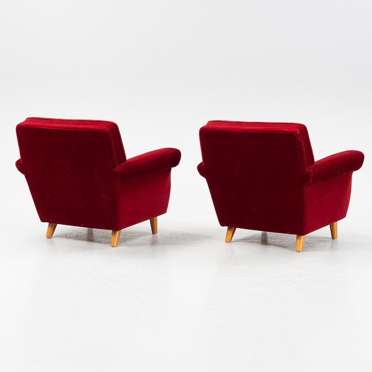 A pair of velvet upholstered easy chairs, mid 20th Century.