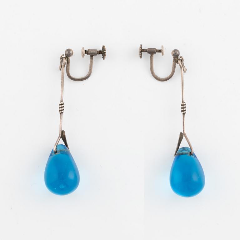 A pair of silver earrings with blue glass drops, likely by Torun Bülow-Hübe.