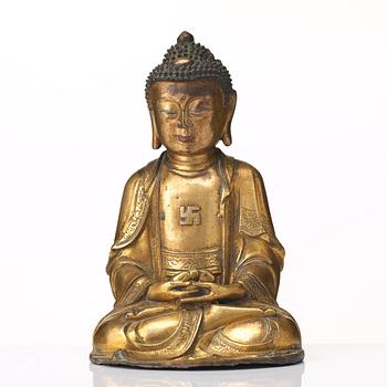 A gilt bronze figure of Amithaba Buddha, Ming dynasty (1368-1644).