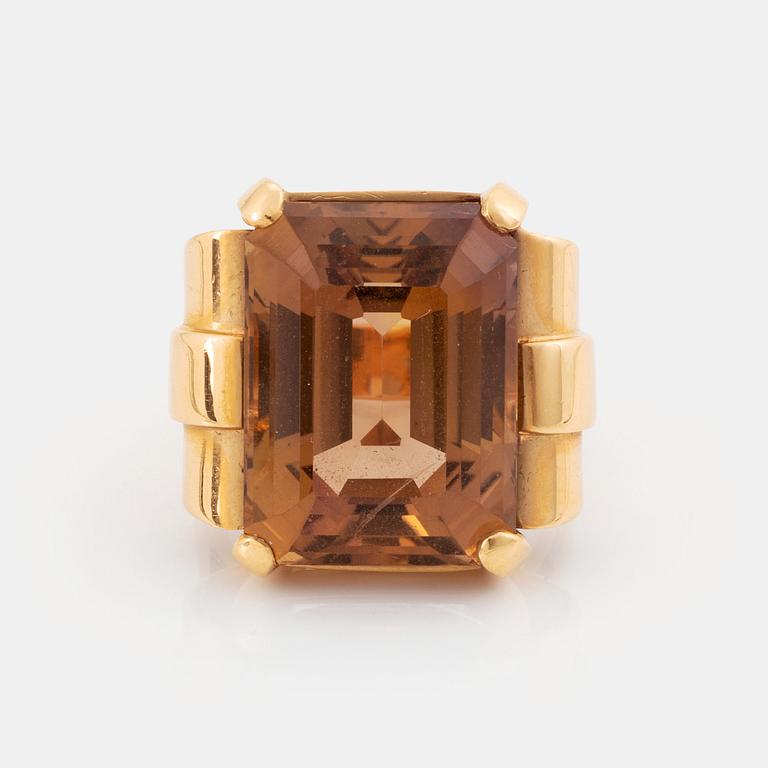 An 18K gold ring set with a step-cut citrine.