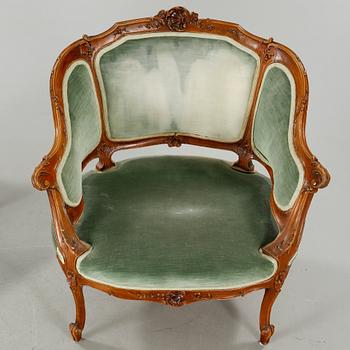 A rococo style sofa, two lounge chairs and a table, around the year 1900 and first half of the 20th century.
