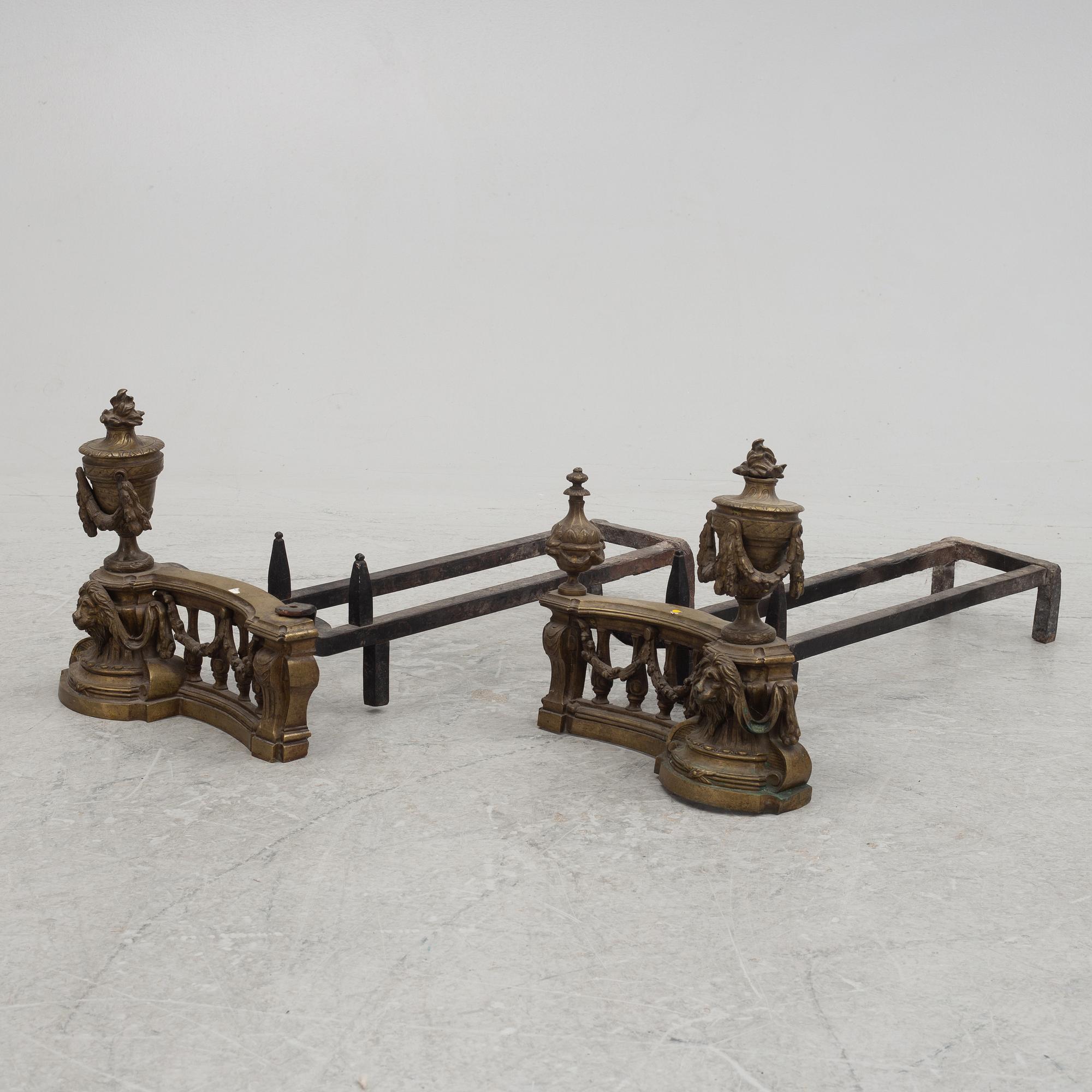 A pair of brass and forged iron andirons, late 19th century.