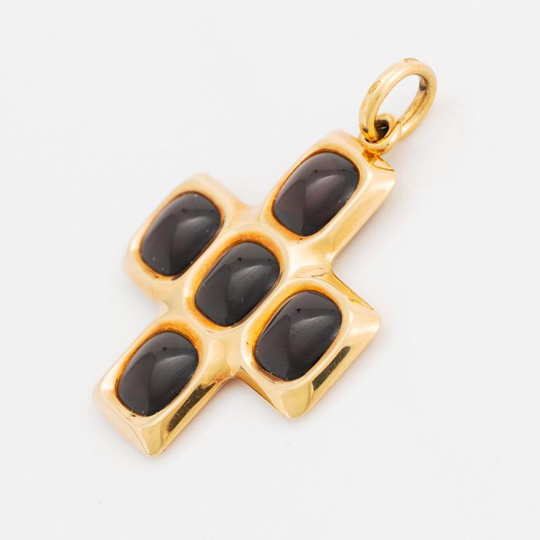 An 18K gold and garnet Pomellato cross.