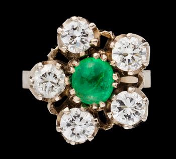 723. A gold, emerald and diamond ring.