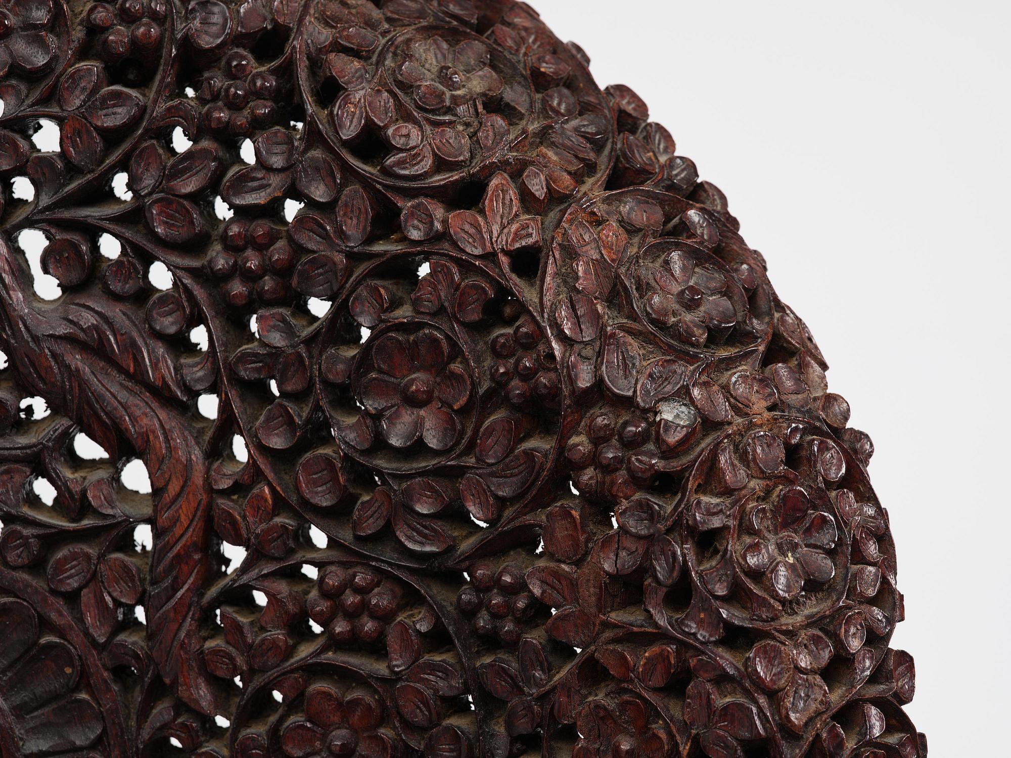 A pair of carved 'blackwood' armchairs, Bombay presidency, British Raj, circa 1880.