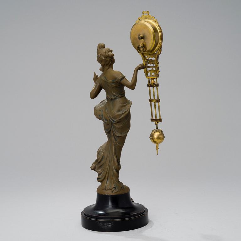 A 1930s Junghans swinger clock with girl sculpture.