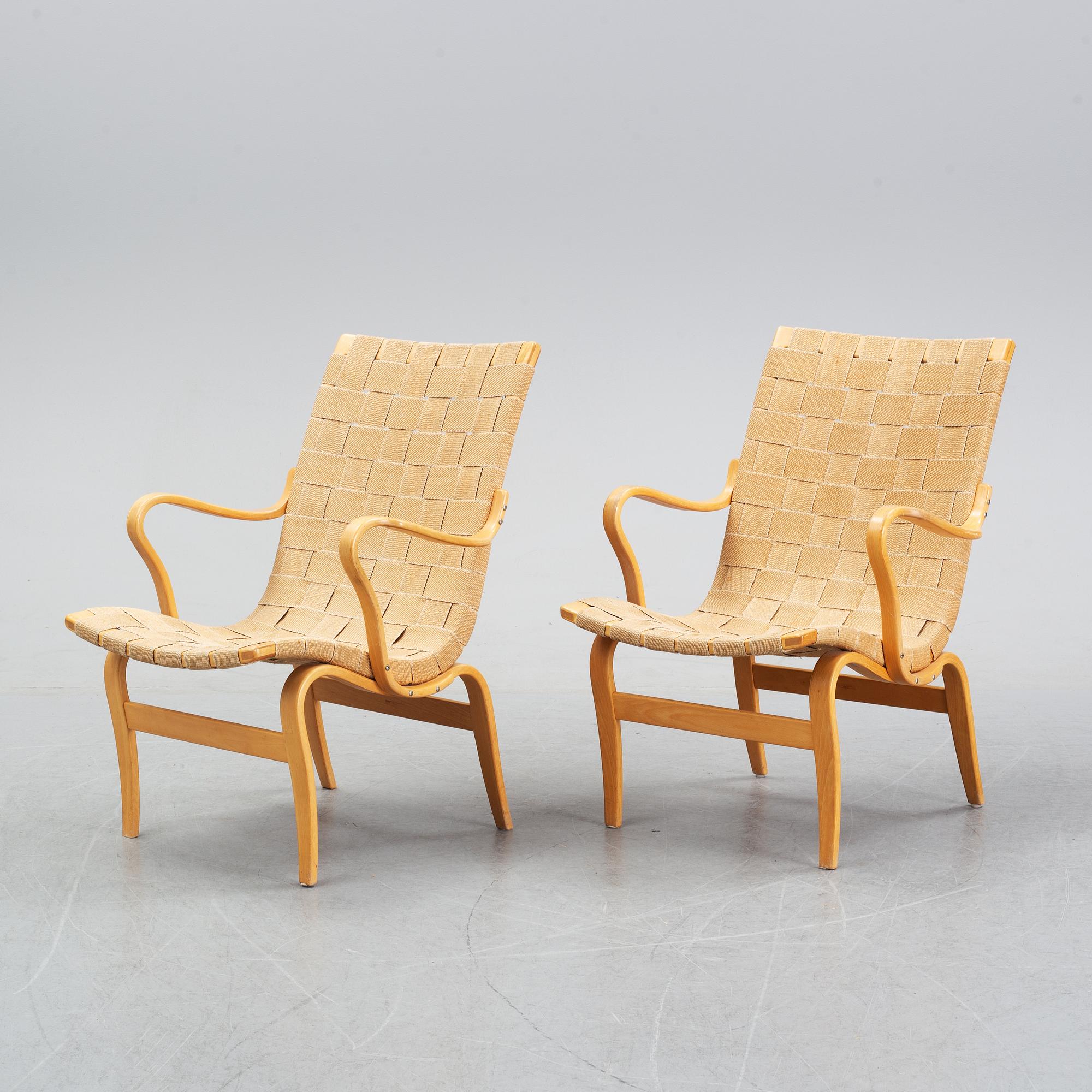 A pair of 'Eva' easy chairs by Bruno Mathsson for Firma Karl Mathsson, dated 1974.
