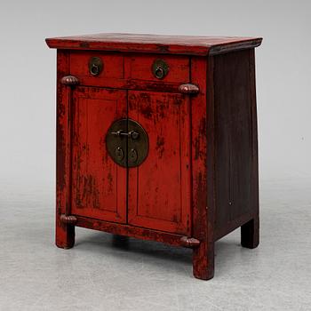 A red lacqured Chinese cabinet, 20th Century.